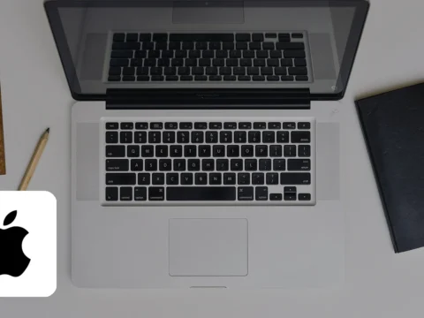 Photorealistic photo of a MacBook Pro on a desk with the Apple logo