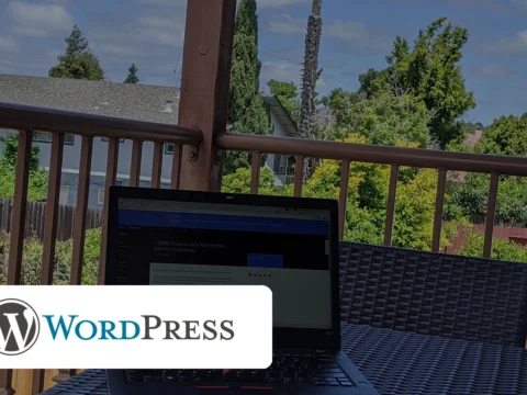 Photorealistic image of a laptop in shadow with the WordPress logo, warning of a backdoor attack